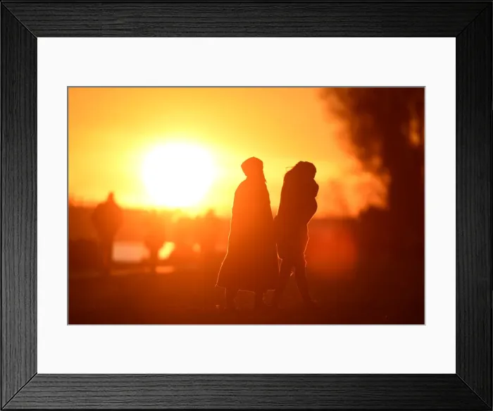 Framed Print : People enjoy the sunset at the Elbe river in Hamburg