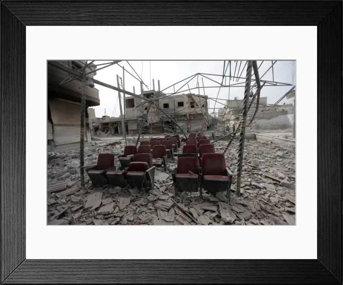 Framed Print : Damaged seats are pictured amidst rubble of buildings in the northern Syrian town of Framed Print : Damaged seats are pictured amidst rubble of buildings in the northern Syrian town of