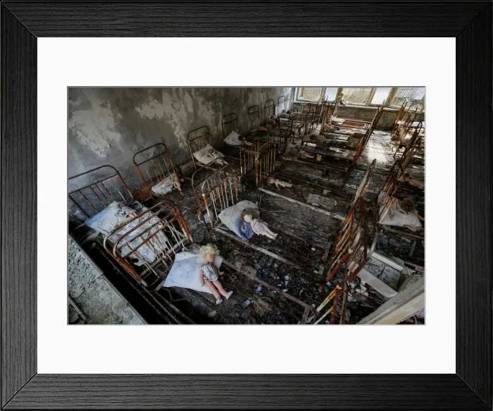 Framed Print : Dolls, which were placed by a visitor, lie at beds at a kindergarten in the abandoned Framed Print : Dolls, which were placed by a visitor, lie at beds at a kindergarten in the abandoned