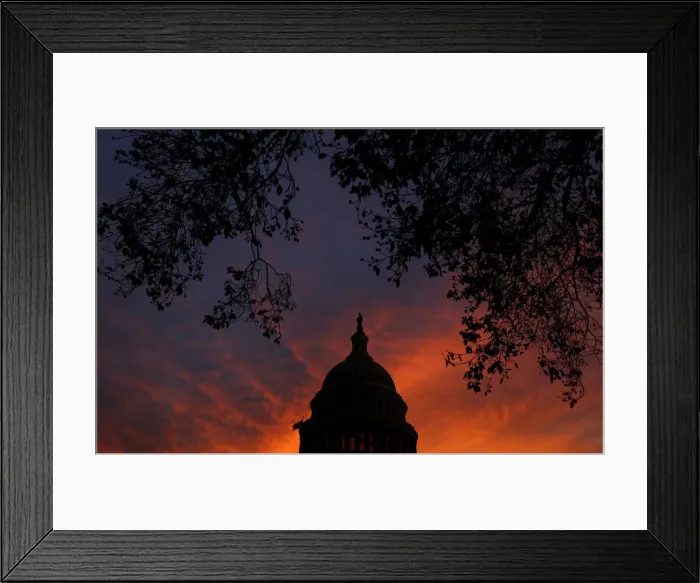 Framed Print : A view shows the dome of the U. S. Capitol building during sunset in Washington Framed Print : A view shows the dome of the U. S. Capitol building during sunset in Washington