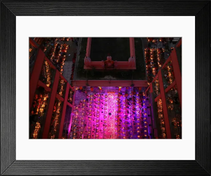 Framed Print : Hindu devotees sit together on the floor of a temple to observe Rakher Upabash, in Dhaka