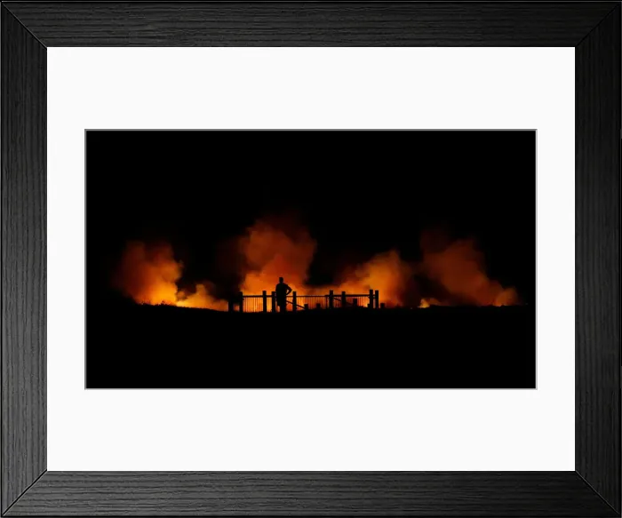 Framed Print : A man watches a bushfire burning on the Kurnell Peninsula on Sydneys southern coast Framed Print : A man watches a bushfire burning on the Kurnell Peninsula on Sydneys southern coast
