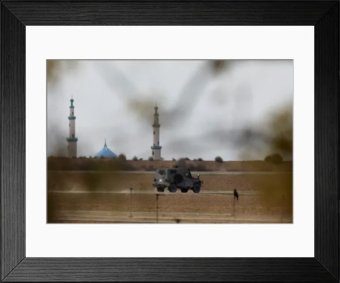Framed Print : An Israeli military jeep drives near the area where the Israeli forces said a