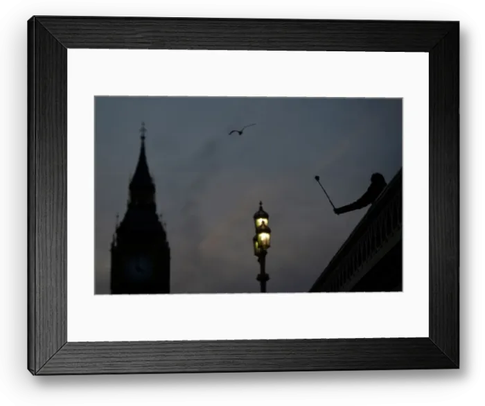 Framed Print : A person takes a photograph on Westminster Bridge at dusk in central London Framed Print : A person takes a photograph on Westminster Bridge at dusk in central London