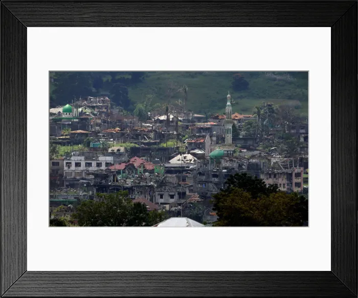 Framed Print : Damaged buildings and houses are seen as government troops continue their assault on its