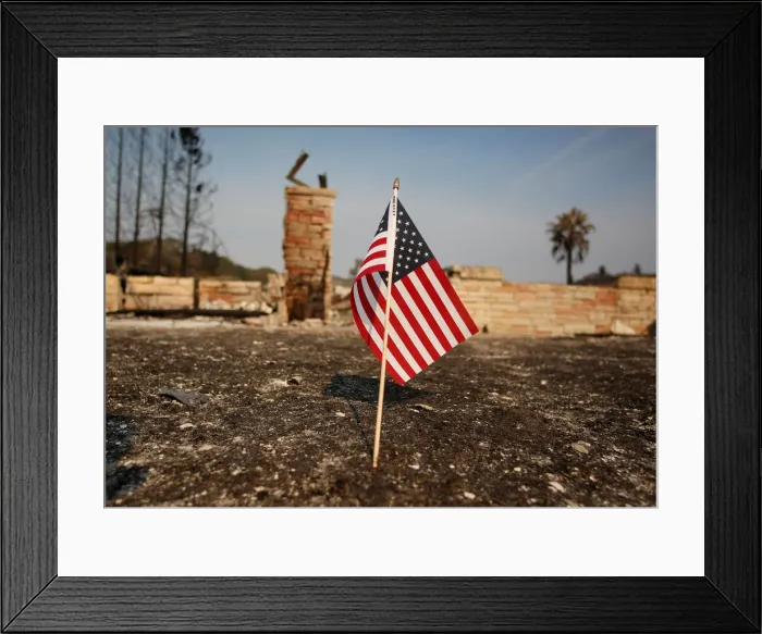 Framed Print : An American flag stands in front of a home destroyed after a wildfire tore through Santa Framed Print : An American flag stands in front of a home destroyed after a wildfire tore through Santa