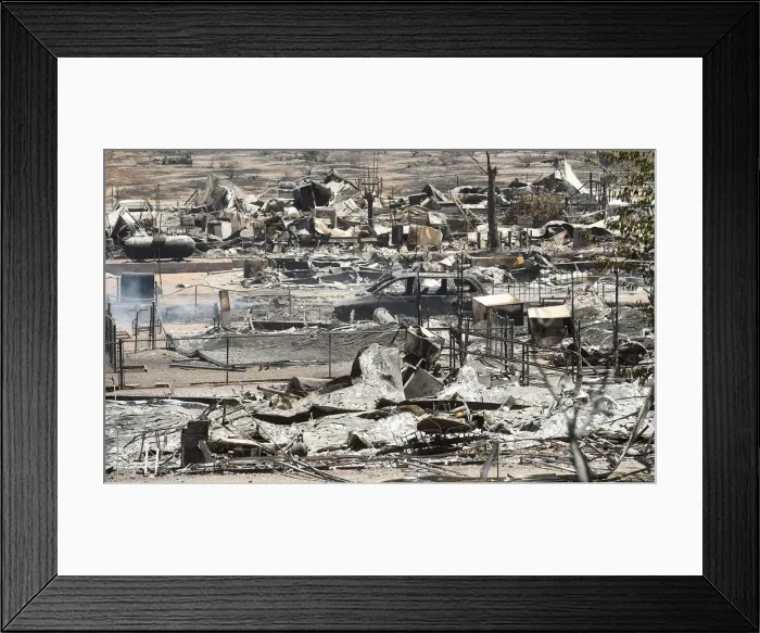 Framed Print : The remains of scorched homes line a street after the Erskine Fire burned through South