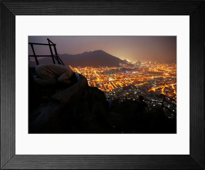Framed Print : A Muslim pilgrim prays at Mount Al-Noor ahead of the annual haj pilgrimage in the holy