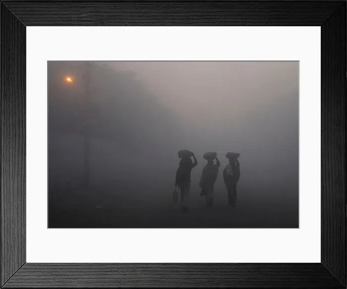 Framed Print : Men walk along a street on a foggy morning in the old quarters of Delhi