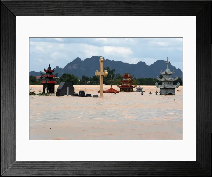 Framed Print : Submerged tombs are seen at a flooded village after heavy rainfall in Ninh Binh province Framed Print : Submerged tombs are seen at a flooded village after heavy rainfall in Ninh Binh province