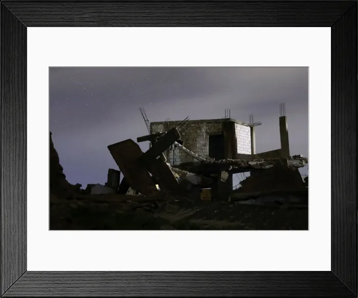 Framed Print : Damaged houses are pictured at night in the rebel-held area, in the city of Daraa, Syria Framed Print : Damaged houses are pictured at night in the rebel-held area, in the city of Daraa, Syria