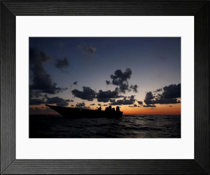 Framed Print : Libyan migrants on a wooden boat await rescue by the migrant search