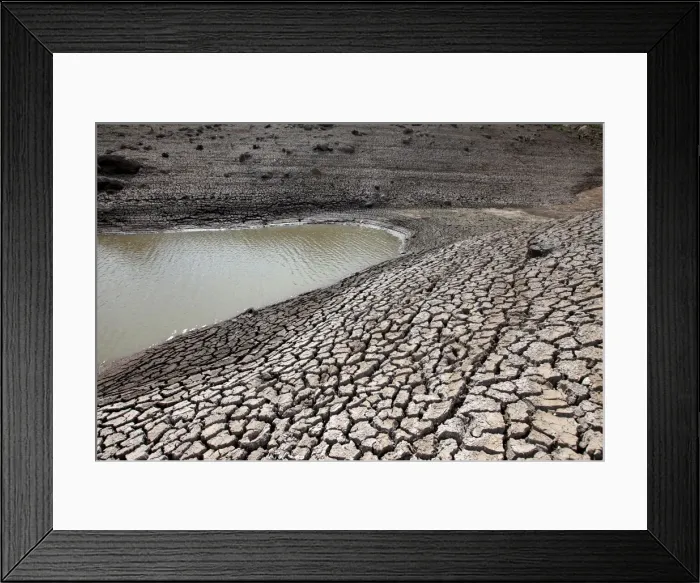 Framed Print : Dried mud is seen during a low-level period of water in Concepcion reservoir on Framed Print : Dried mud is seen during a low-level period of water in Concepcion reservoir on