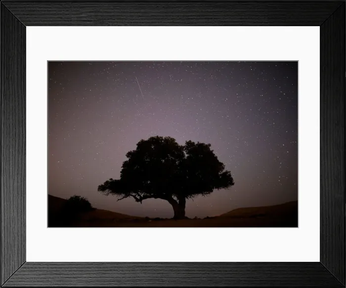 Framed Print : A long exposure shows a meteor streaking across the sky in the early morning during Framed Print : A long exposure shows a meteor streaking across the sky in the early morning during