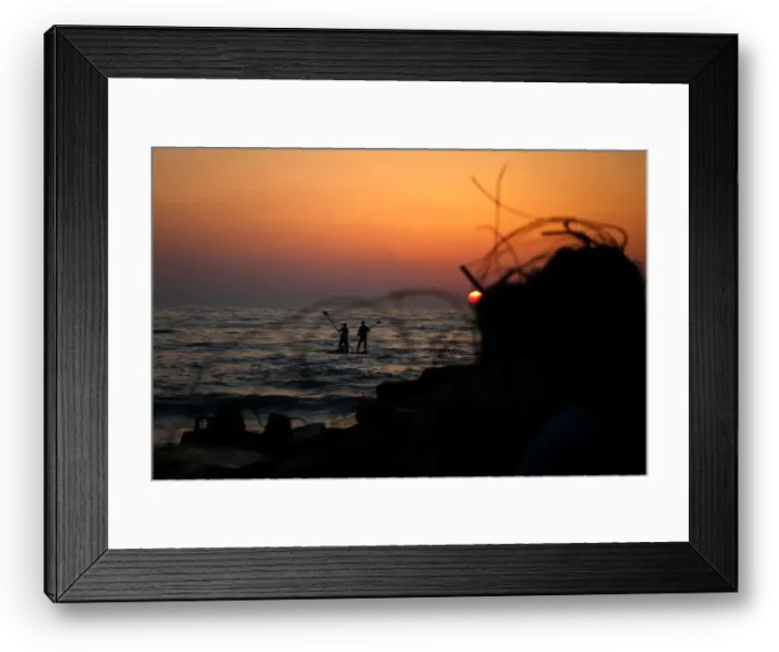 Framed Print : Palestinians ride a boat in the Mediterranean Sea in the northern Gaza Strip