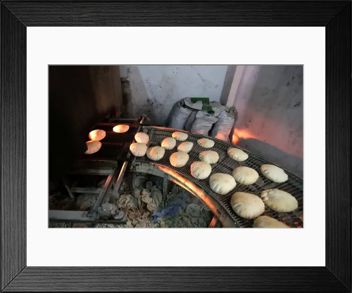 Framed Print : Bread is baked before the time for iftar, or breaking fast