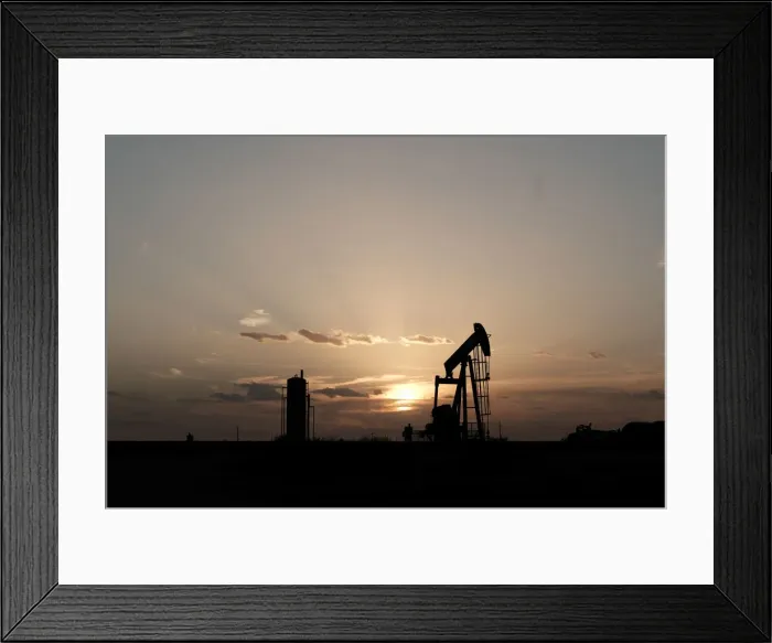 Framed Print : Oil pump jacks work at sunset near Midland