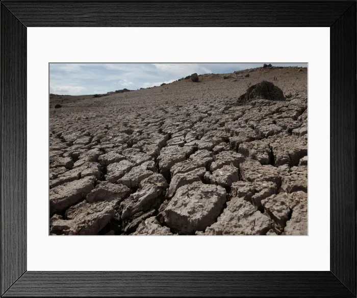 Framed Print : Dried mud is seen during a low-level period of water in Concepcion reservoir on Framed Print : Dried mud is seen during a low-level period of water in Concepcion reservoir on
