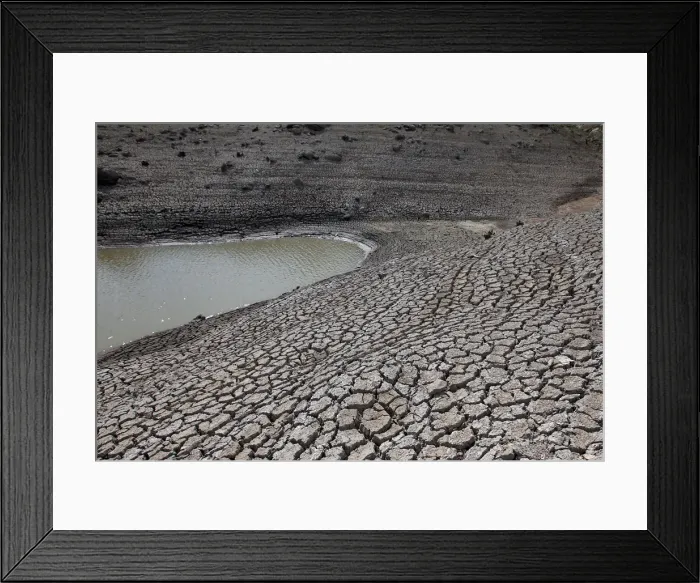 Framed Print : Dried mud is seen during a low-level period of water in Concepcion reservoir on Framed Print : Dried mud is seen during a low-level period of water in Concepcion reservoir on
