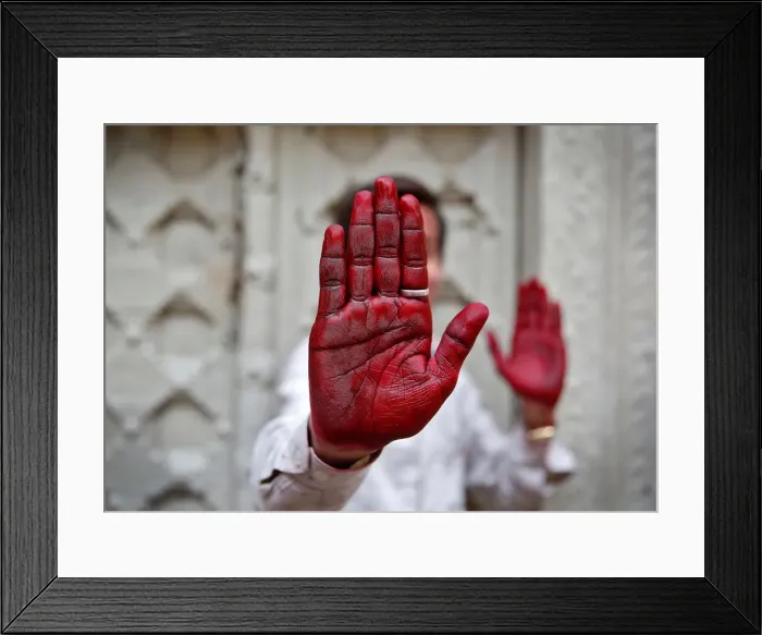 Framed Print : A Hindu devotee displays his inked hand after taking part in the religious festival of Framed Print : A Hindu devotee displays his inked hand after taking part in the religious festival of
