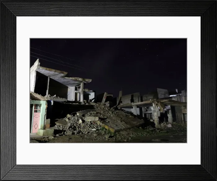 Framed Print : Damaged houses are pictured at night in the rebel-held area, in the city of Daraa, Syria Framed Print : Damaged houses are pictured at night in the rebel-held area, in the city of Daraa, Syria