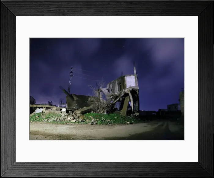 Framed Print : Damaged houses are pictured at night in the rebel-held area, in the city of Daraa, Syria Framed Print : Damaged houses are pictured at night in the rebel-held area, in the city of Daraa, Syria