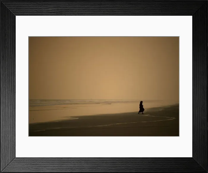 Framed Print : A woman walks along the beach at sunset in Coxs Bazar Framed Print : A woman walks along the beach at sunset in Coxs Bazar