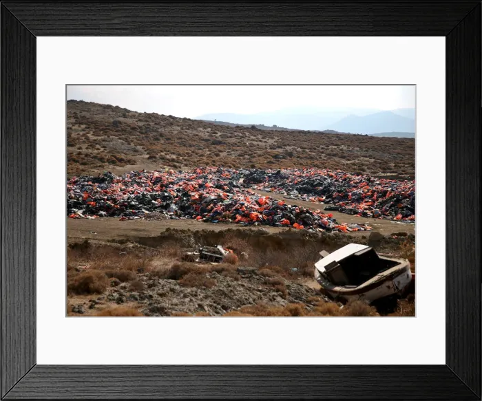 Framed Print : Thousands of lifejackets left by migrants and refugees are piled up at a garbage dump Framed Print : Thousands of lifejackets left by migrants and refugees are piled up at a garbage dump