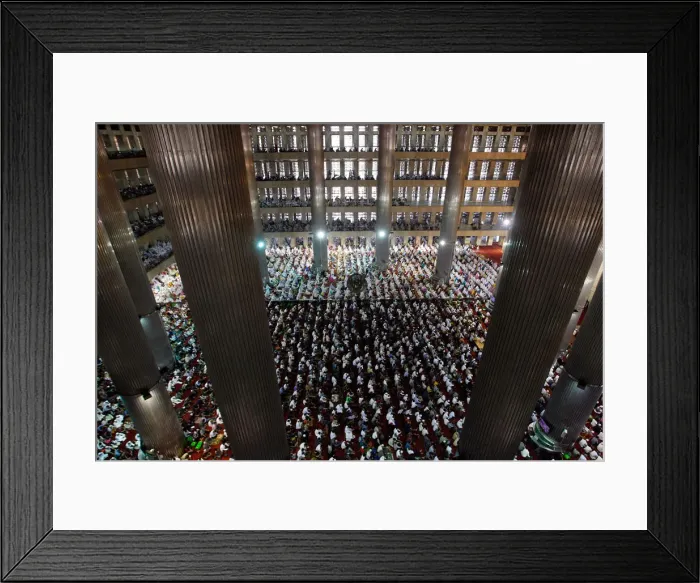 Framed Print : People attend prayers for the Muslim holiday of Eid Al-Adha at Istiqlal Mosque in Jakarta