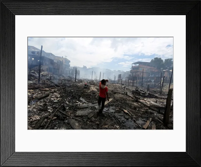 Framed Print : Resident is seen after a fire at Educandos neighbourhood, on a branch of the Rio Negro Framed Print : Resident is seen after a fire at Educandos neighbourhood, on a branch of the Rio Negro