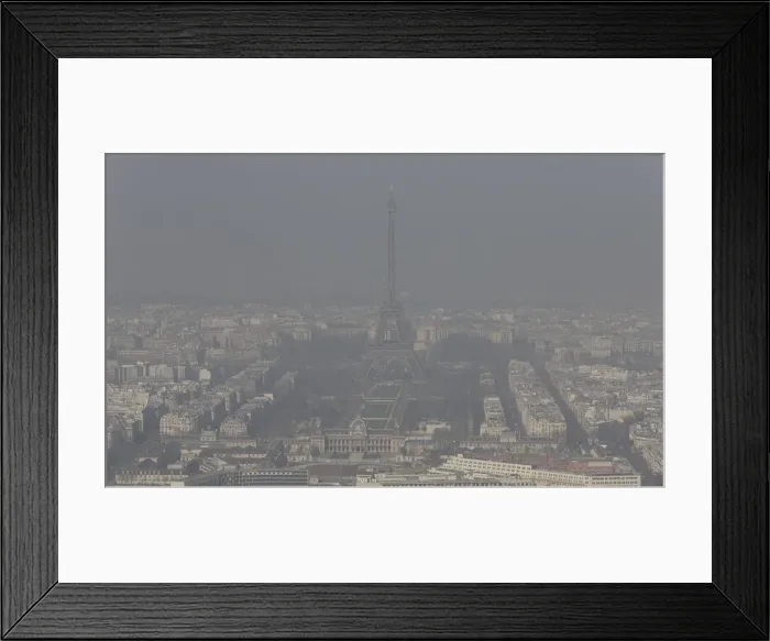 Framed Print : A general view shows the Eiffel tower and the Paris skyline through a small-particle haze Framed Print : A general view shows the Eiffel tower and the Paris skyline through a small-particle haze