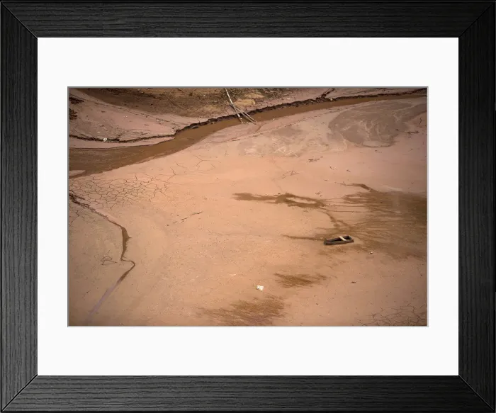 Framed Print : A boat sits on the nearly dry lake bed behind the Nazare Paulista dam
