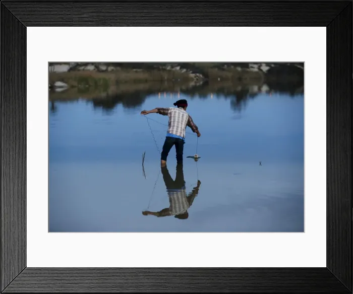 Framed Print : A Thai migrant catches crabs at an estuary, on Zikim beach in the Mediterranean sea Framed Print : A Thai migrant catches crabs at an estuary, on Zikim beach in the Mediterranean sea