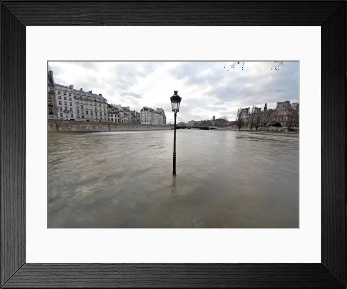 Framed Print : The waters of the Seine River flow out of its banks at the tip of the Ile Saint Louis Framed Print : The waters of the Seine River flow out of its banks at the tip of the Ile Saint Louis