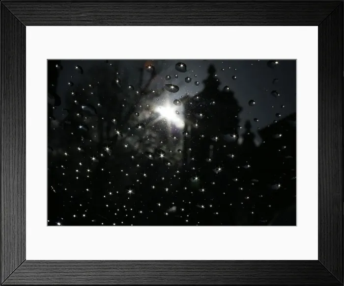 Framed Print : The sun is seen reflected in raindrops on a window after shower in London Framed Print : The sun is seen reflected in raindrops on a window after shower in London