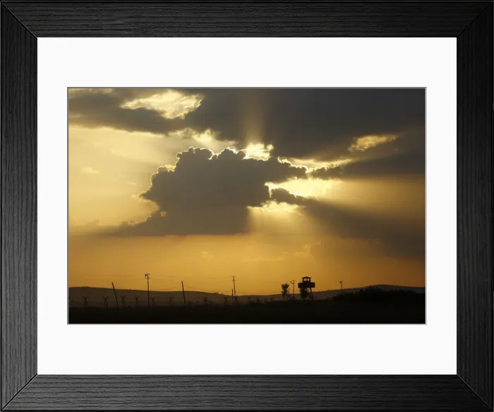 Framed Print : A Turkish border watch tower is silhouetted against the sunset at the Turkish-Syrian