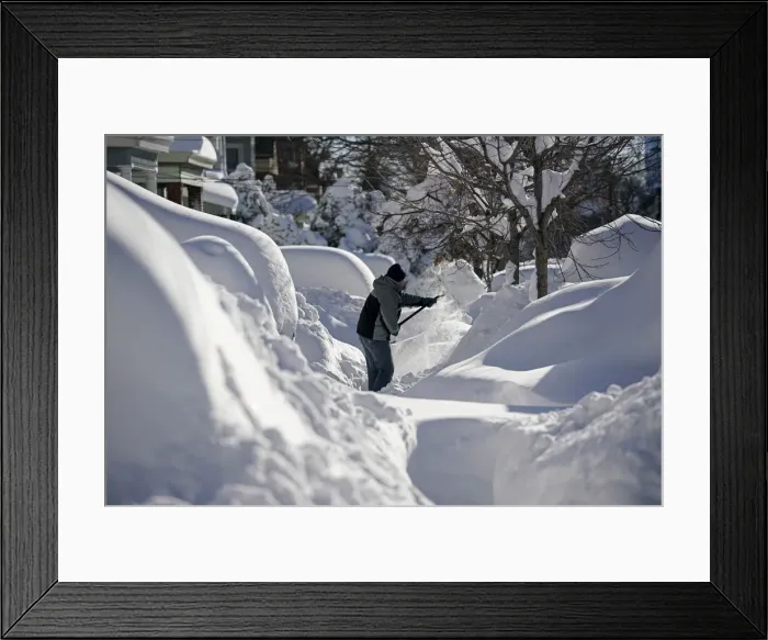 Framed Print : A resident shovels snow away from the entrance to his home in Union City Framed Print : A resident shovels snow away from the entrance to his home in Union City