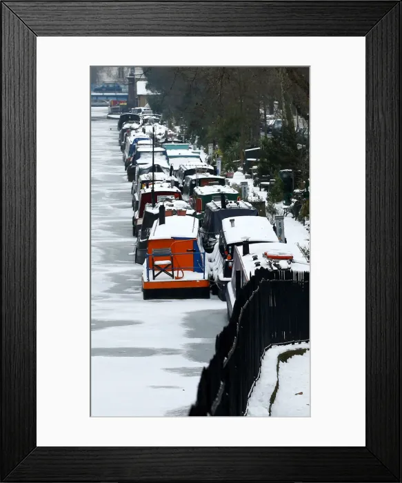 Framed Print : Canal boats are frozen at their berths on the Regents Canal in Maida Vale in London Framed Print : Canal boats are frozen at their berths on the Regents Canal in Maida Vale in London