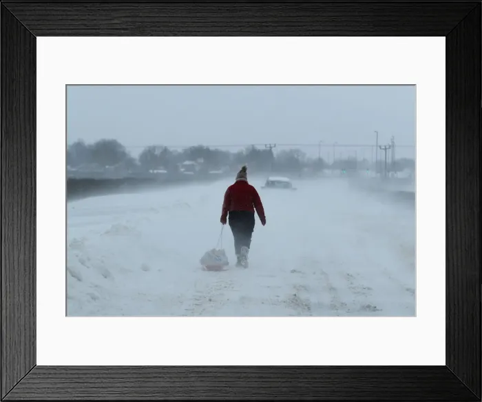 Framed Print : A woman pulls shopping on a sledge near Lincoln Framed Print : A woman pulls shopping on a sledge near Lincoln