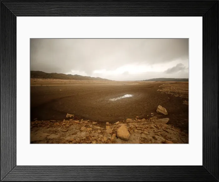 Framed Print : Sand blows across a normally submerged area at Theewaterskloof Dam near Cape Town