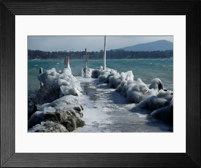 Framed Print : A frozen pier is seen during a windy winter day near Lake Leman in Geneva Framed Print : A frozen pier is seen during a windy winter day near Lake Leman in Geneva
