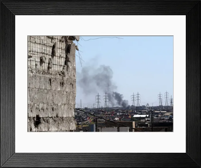 Framed Print : Smoke is seen as members of the Iraqi forces clash with Islamic State fighters on a Framed Print : Smoke is seen as members of the Iraqi forces clash with Islamic State fighters on a
