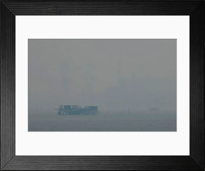 Framed Print : A fishing kelong is pictured, in front of cranes at a Malaysian shipyard shrouded by haze Framed Print : A fishing kelong is pictured, in front of cranes at a Malaysian shipyard shrouded by haze