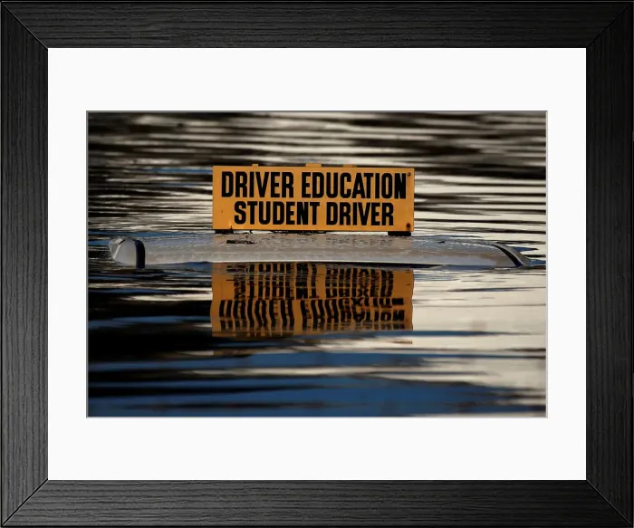 Framed Print : The roof a student driver car is pictured partly underwater as a result of Hurricane