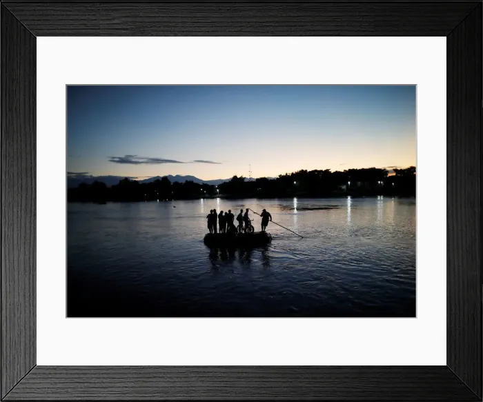 Framed Print : Central American migrants cross the Suchiate river into Mexico on a raft as they try to