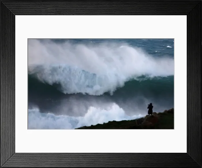 Framed Print : A photographer takes pictures of waves breaking on the Brittany coast at Audierne in