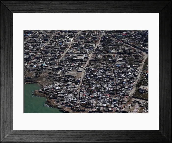 Framed Print : People walk down streets next to destroyed houses after Hurricane Matthew hit Jeremie Framed Print : People walk down streets next to destroyed houses after Hurricane Matthew hit Jeremie