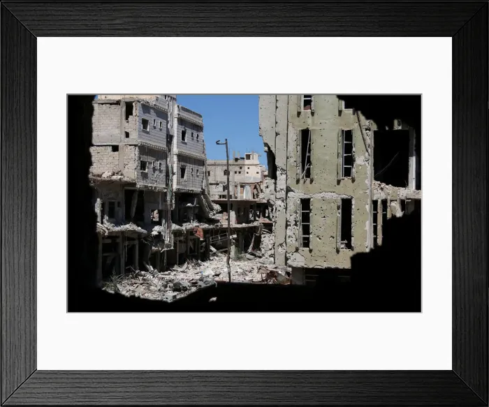 Framed Print : Debris from damaged buildings are seen from a hole at a rebel-held area in Deraa Framed Print : Debris from damaged buildings are seen from a hole at a rebel-held area in Deraa