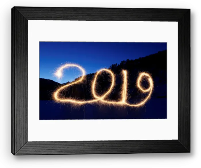 Framed Print : The numbers 2019 are written in the air with a sparkler near a tourist camp outside