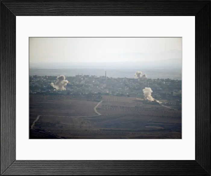 Framed Print : Smoke from explosions rises during fighting in the village of Jubata Al Khashab in Syria Framed Print : Smoke from explosions rises during fighting in the village of Jubata Al Khashab in Syria